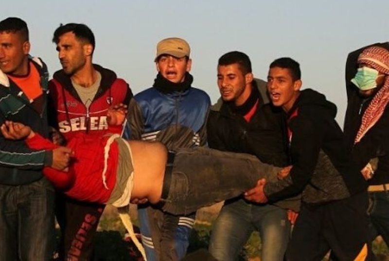 Palestinians evacuate a wounded demonstrator during a protest at the fence separating Gaza from Israel. (Photo: File)  By Ramzy Baroud