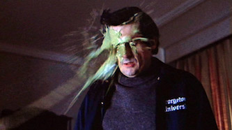 The scene from The Exorcist (1973) where the demon-possessed child (Linda Blair) spews a stream of pea soup-like projectile vomit into the face of kindly old Max von Sydow, as Father Merrin, the priest come to rescue her.